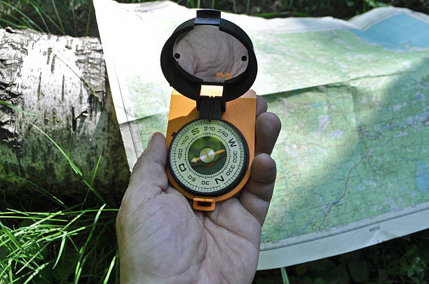 istock Compass in hand, against background of the map. 500017529