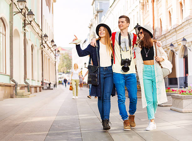 istock Three happy friends hugging in row and walking 500017790