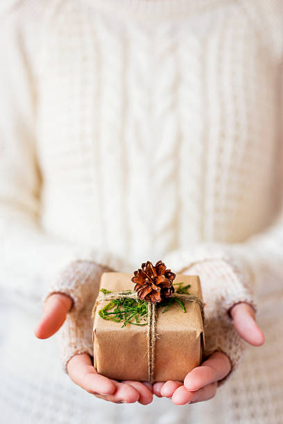 istock Woman in knitted sweater holding a present. 500018006