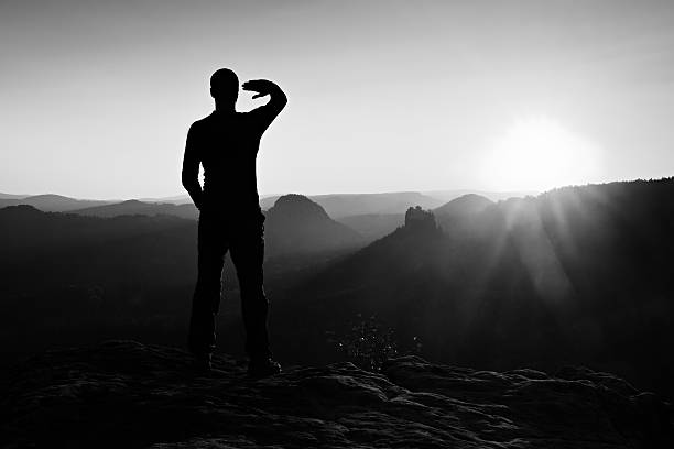 istock Young sportsman shadowing eyes from bright rays of daybreak Sun 500018038