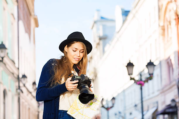 istock young woman in hat shooting with camera 500018906