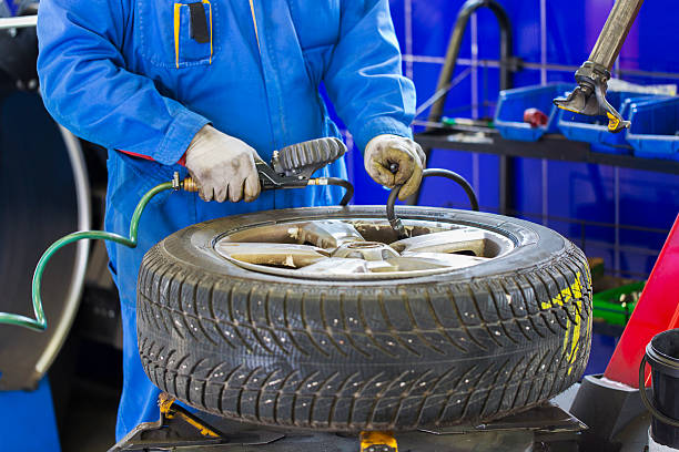 istock Auto mechanic is changin tire...prepairing car for winter 500020920