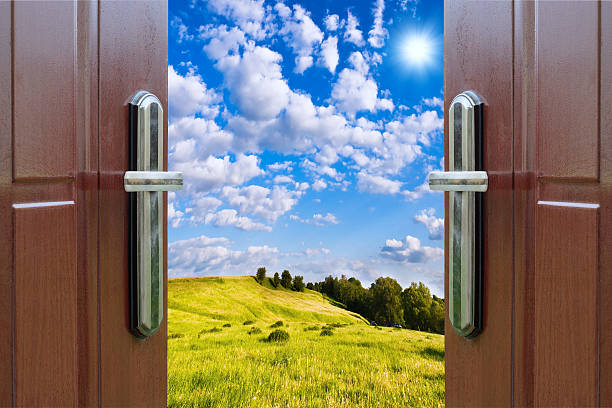 istock open door with  view green meadow illuminated by bright sunshine 500021561