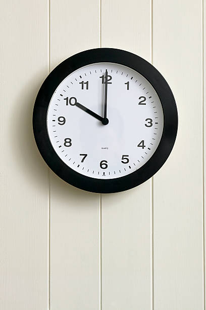 Clock on painted wood panel wall stock photo