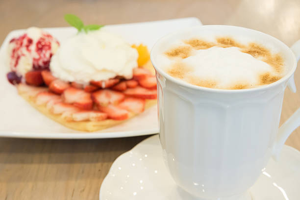 istock Cappuccino coffee cup and vanilla ice cream with strawberry 500023283