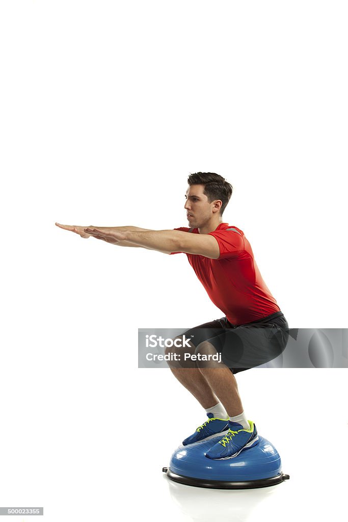 squat exercise on ball bosu ball exercise Activity Stock Photo