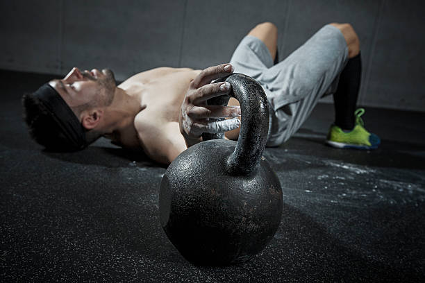 rest after training man on the ground exhausted after a hard workout ganar stock pictures, royalty-free photos & images