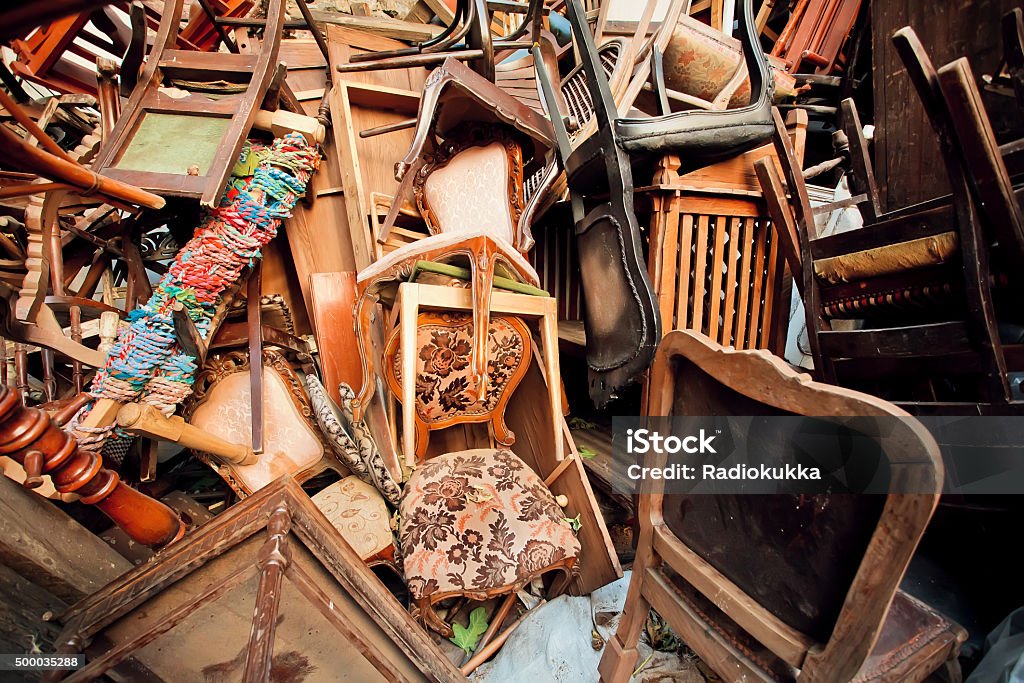 Dump old wooden chairs chairs, one on the other Dump old wooden chairs and vintage chairs, one on the other, thrown into the street Garbage Stock Photo