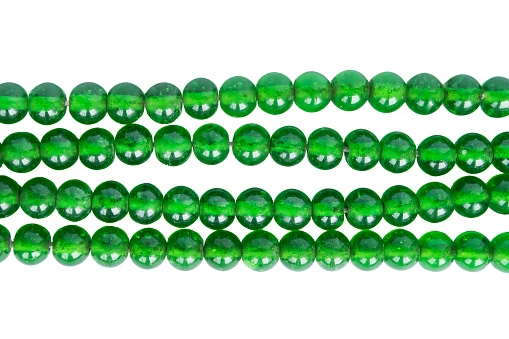 Strings of green glass beads isolated over white