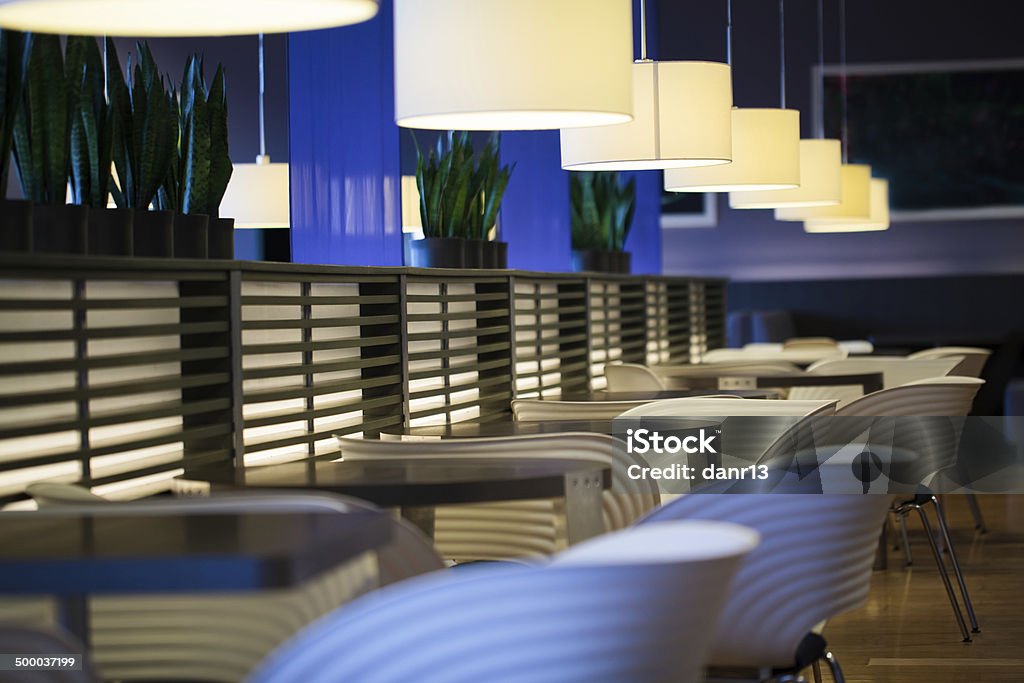 Empty modern restaurant interior Empty modern restaurant interior with chairs, tables and hanging lamps Lighting Equipment Stock Photo