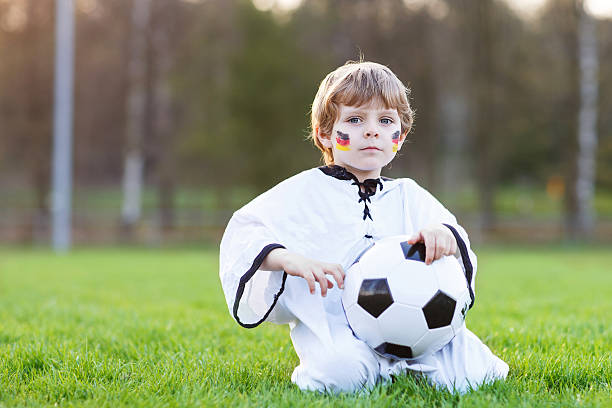 kleinen ventilator junge im öffentlichen anzeige des fußball oder fußball - playing field goalie soccer player little boys stock-fotos und bilder