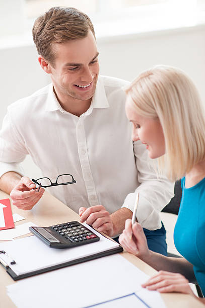 istock Cheerful young Real Estate Agent is consulting a client 500037770