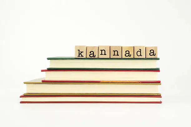 Photo of Kannada language word on wood stamps and books