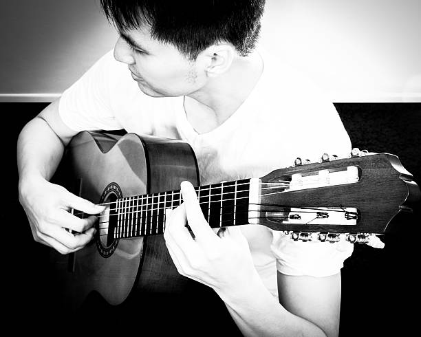 istock Asian Musician plays Acoustic Guitar 500038339