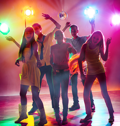 Young people having fun and dancing at a holiday party