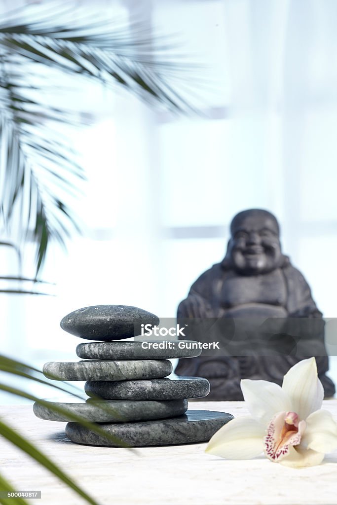 Hot Stones, Jade, Buddha Massage table with bhudda, hot stones and orchid Blue Stock Photo