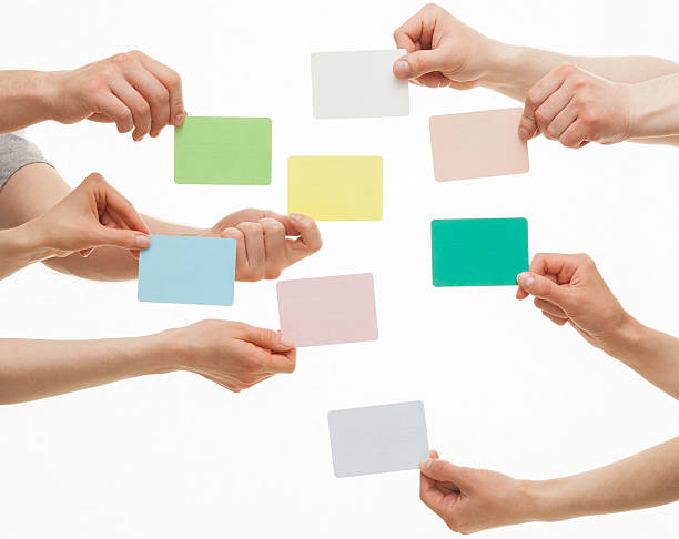 istock Many hands holding colorful paper cards 500044832
