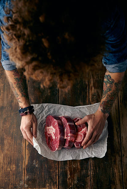 istock Very top view curly head butcher packing three steaks 500044930