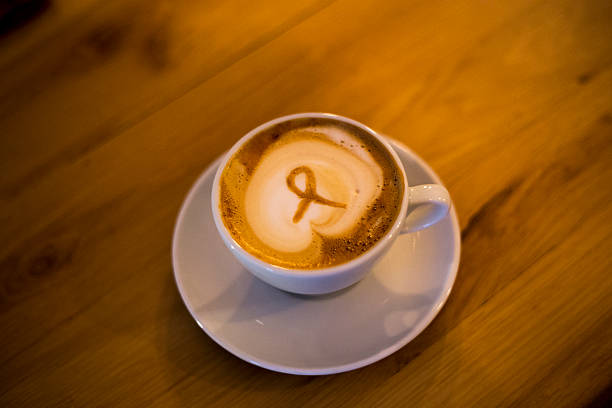 istock Cup of hot latte art coffee on wooden table 500047870