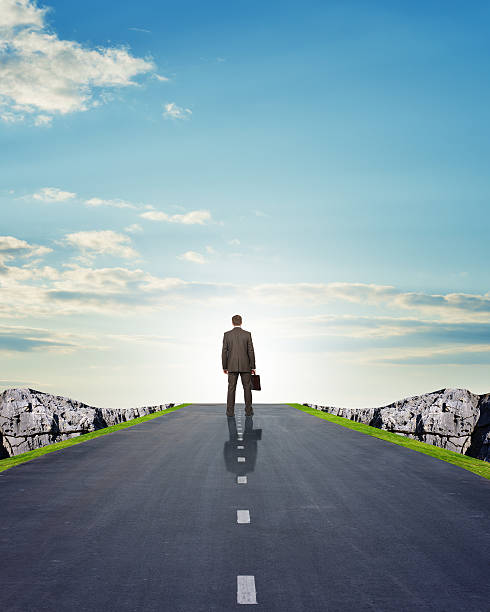 istock Businessman walking on road with mountains 500049220