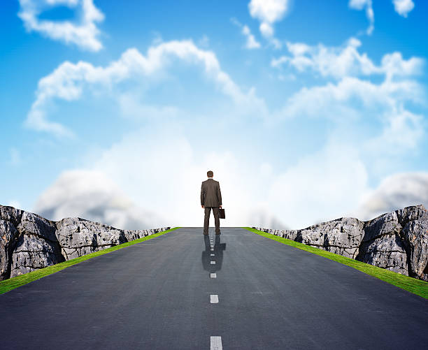 istock Businessman on road with mountains 500056442