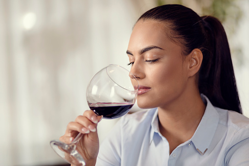Young woman drinking red wine