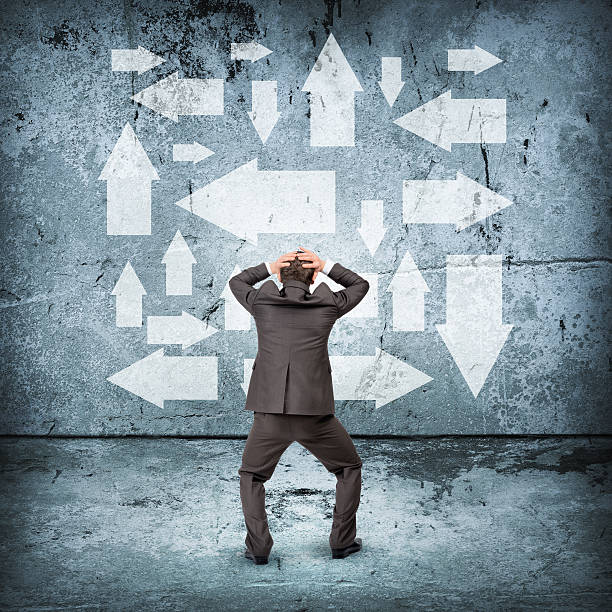 istock Scared businessman in front of different ways 500056594