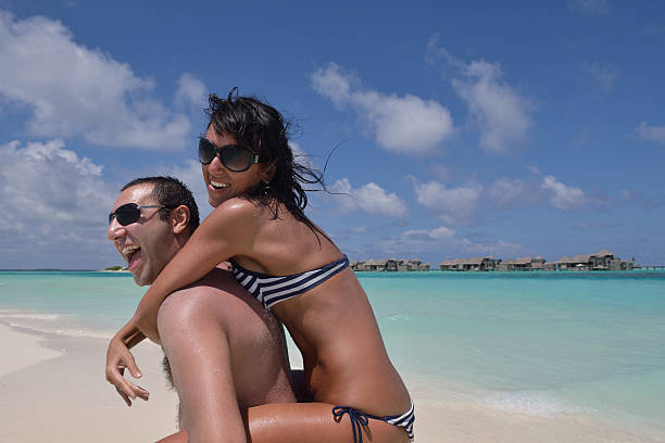 istock happy young couple have fun on beach 500057738