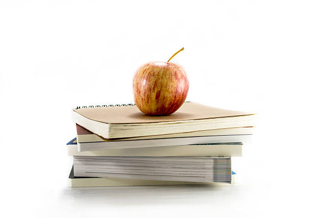 istock Isolated red apple with the books 500057916
