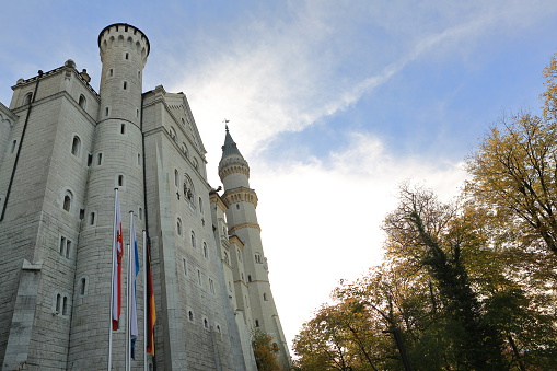 Hohenschwangau, German y- October 24, 2015: Neuschwanstein Castle facade in the village of Hohenschwangau during the afternoon of Saturday, october 24th, 2015. The castle called Schloss Neuschwanstein is visited by more that one and a half million people a year. One of the most visited sitse by tourist in Europe. It was built in the 19th century by the commision of Ludwig II of Bavaria. This was Richard Wagner retreat and home for some time. Now, it is one of the mostpopular places in Bavaria, Germany. It was the inspiration for Walt Disney's Sleeping Beauty Castle in movies and theme parks. Towns that surround the castle and are the places to go there are Fussen, Hohenschwangau and Schwangau.