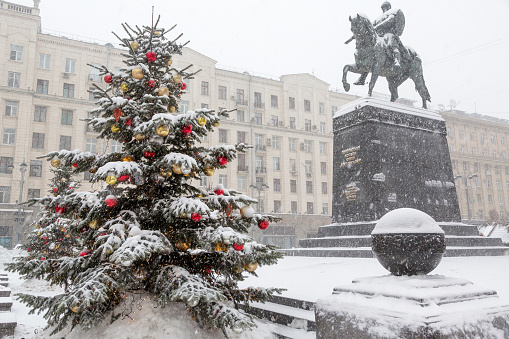View of the monument to Yuri Dolgoruky on Tverskaya square during snowfall at Christmas time at the center of Moscow, Russia