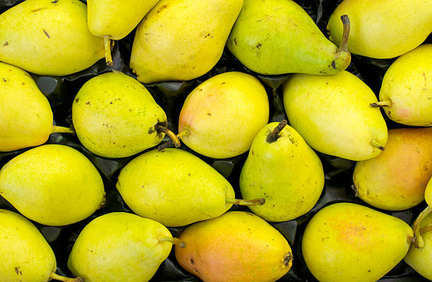 Lots of bright green pears in supermarket.