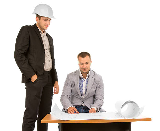 istock Team of architects discussing a project blueprint 500063644