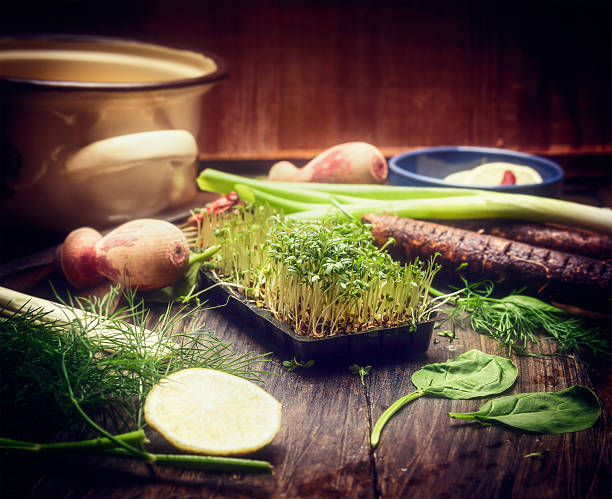 Fresh sprouts on kitchen table with cooking tools and vegetables.