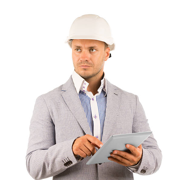 Thoughtful serious architect or engineer Thoughtful serious architect or engineer wearing a hardhat and holding a tablet computer looking off to his right with a pensive expression, isolated on white superintendent stock pictures, royalty-free photos & images