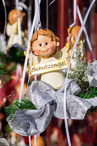 Creative Christmas decoration - a small wooden angel hanging on a branch