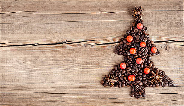 Christmas tree made of coffee beans on wooden table