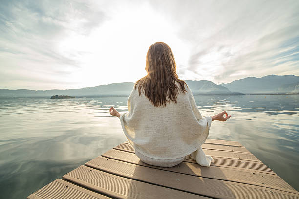 jovem mulher relaxa no lago pier, exercícios de ioga - lake tranquil scene landscape zen like - fotografias e filmes do acervo