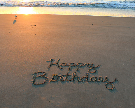 Happy Birthday written in sand