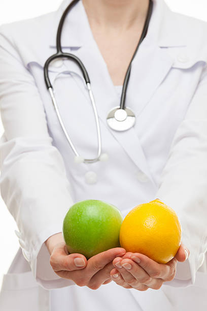 istock Doctor holding fresh fruits 500091540