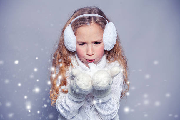 istock Girl blowing on the snow 500093546