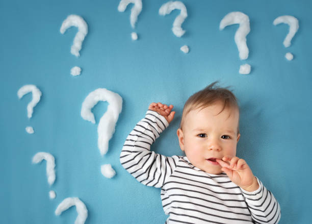 istock funny little boy with lots of question marks 500095928