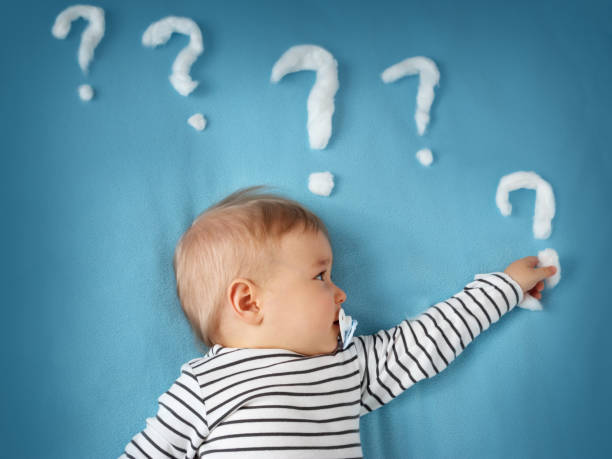 istock funny little boy with lots of question marks 500095950