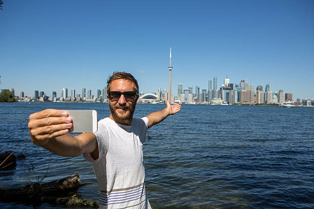 istock Young cheerful man in Toronto-Canada taking a selfie portrait 500107618