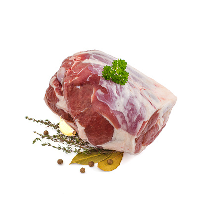 Raw lamb leg with bone, spices, isolated on white