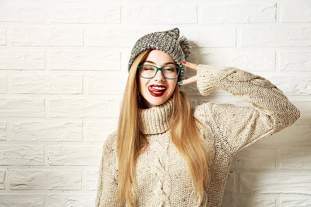 Funny Hipster Girl in Winter Clothes Going Crazy stock photo