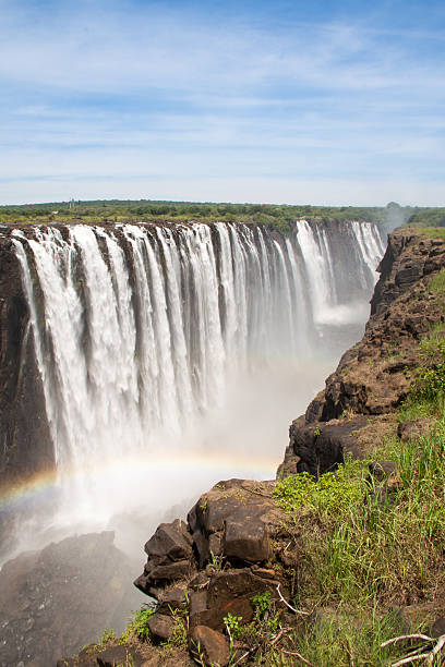 Victoria Falls with Rainbow, Zimbabwe Victoria Falls with Rainbow, Zimbabwe beauty in nature vertical africa southern africa stock pictures, royalty-free photos & images