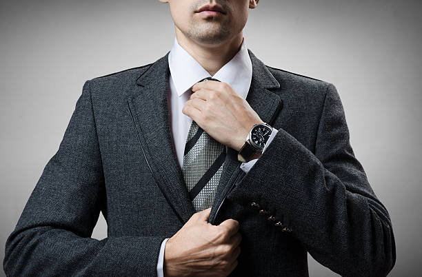 istock man in a tuxedo tie tightens 500110882