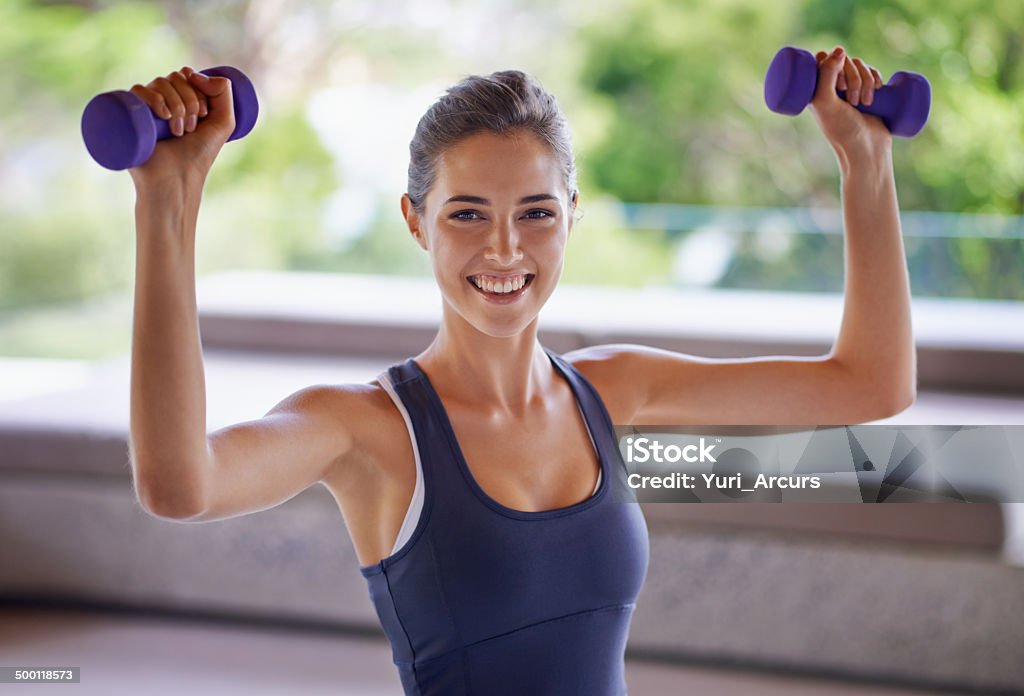 Giving it everything to look her best Portrait of an attractive young woman working out with weightshttp://195.154.178.81/DATA/i_collage/pi/shoots/783594.jpg 20-24 Years Stock Photo