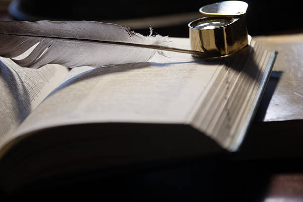 istock open book and quill pen 500119445
